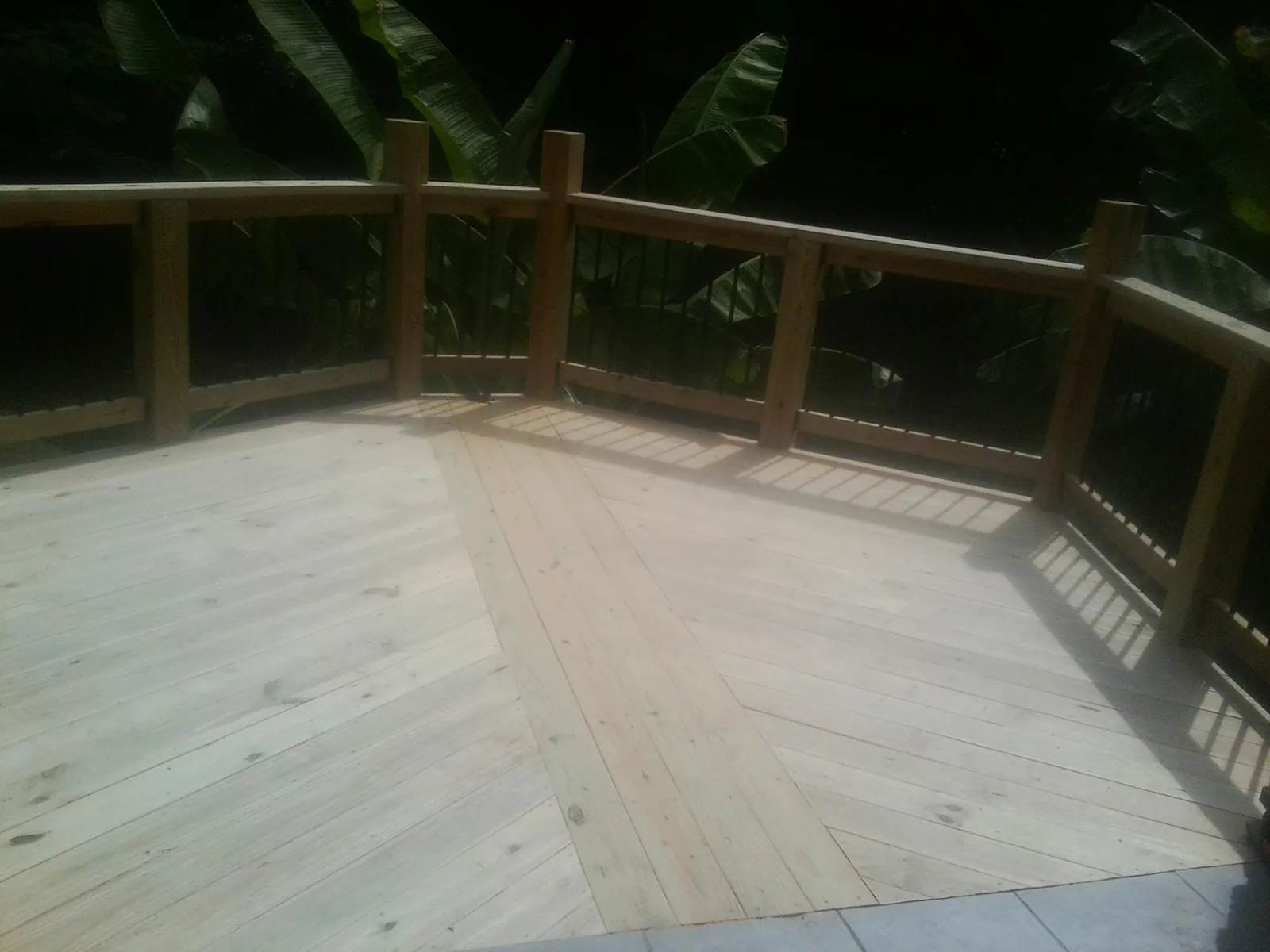 New wood deck and railing built off the back of a home in Patoka